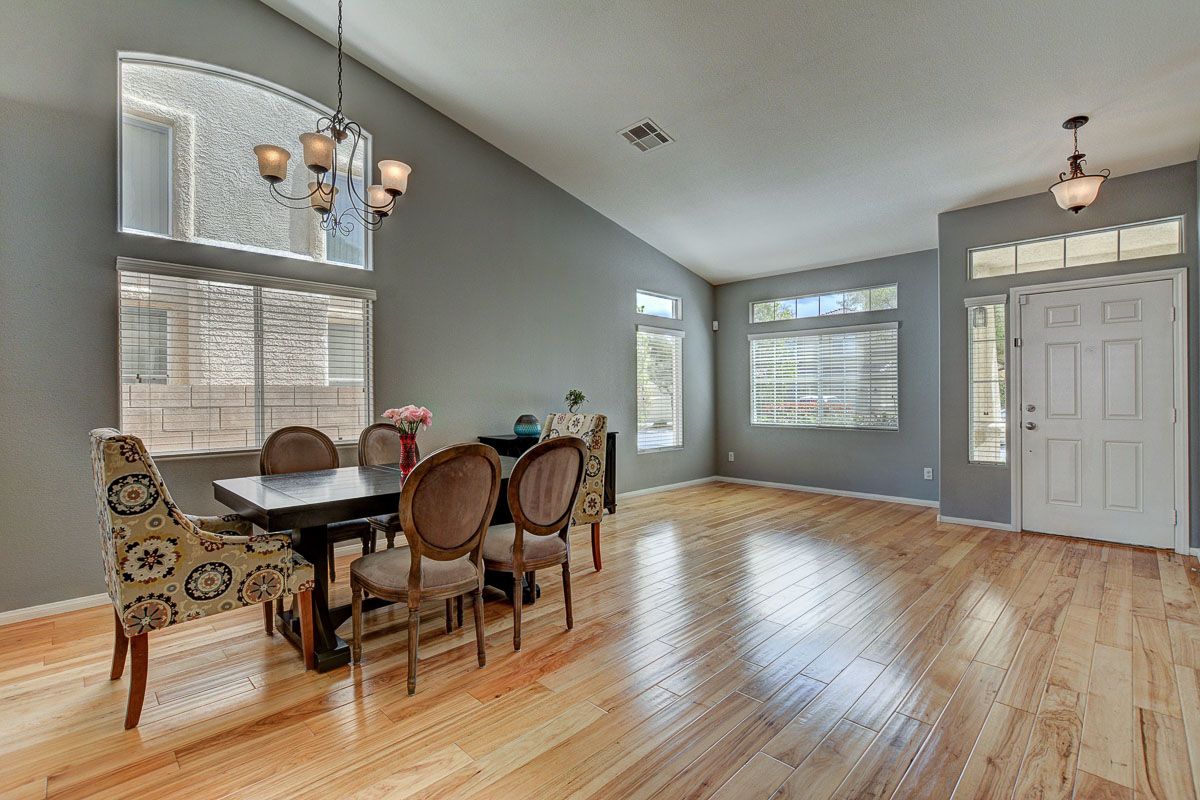 Formal living space with vaulted ceiling, large windows and hickory hardwood floors