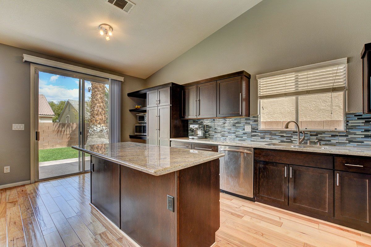 Upgraded kitchen featuring large island with granite countertop