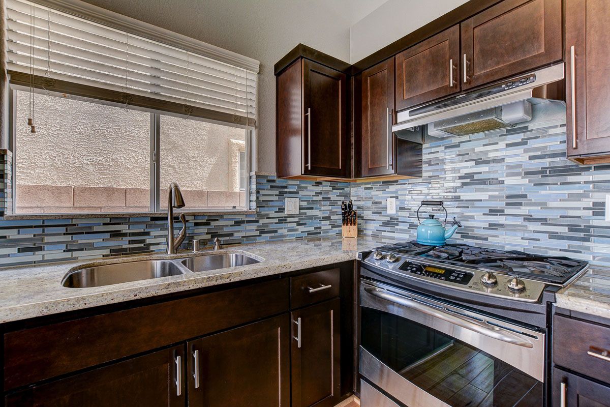 Stainless steel appliances, glass tile backsplash and undermount sink 