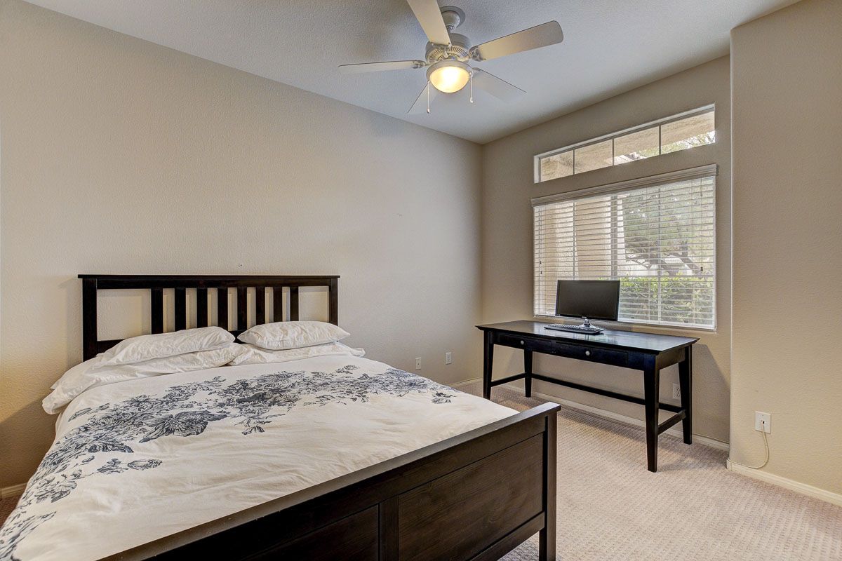 Sizable bedroom with Elfa storage system and ceiling fan
